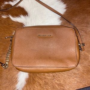 Michael kors cross body brown leather purse.